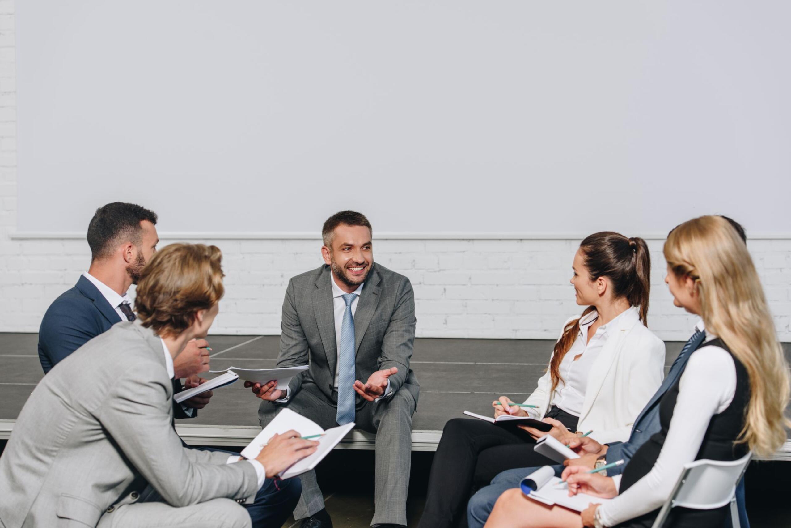 handsome-business-coach-looking-at-businesspeople-2022-12-16-21-02-33-utc (1).jpg